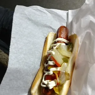 a hot dog with onions and ketchup