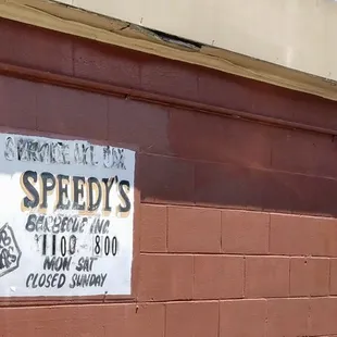 a sign on a brick wall