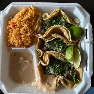 Three Asada taco dinner with rice and beans.