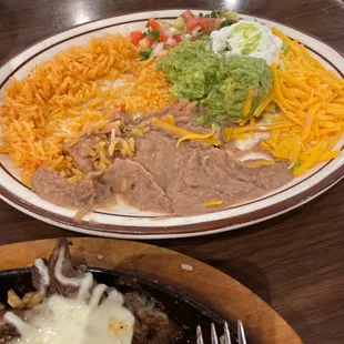 A plate of rice and beans that comes with the fajitas I ordered YUMMY