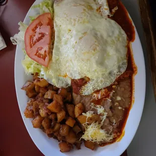Red enchiladas montadas with egg over easy cooked to perfection