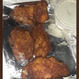 a pan of chicken on tin foil