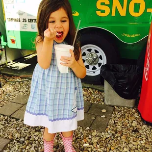 a little girl eating a snack