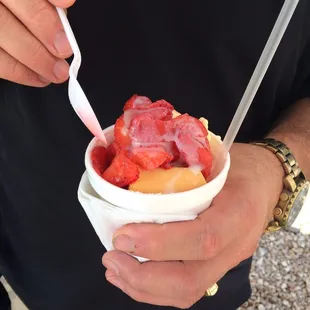 a man holding a bowl of fruit