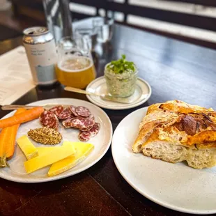 Saucisson Sec, Leelanau Raclette, mustard &amp; pickled carrots, Sourdough Focaccia with Squash &amp; Red Onion, Rainbow Trout Rillettes &amp; herbs.