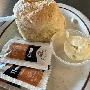 Humongous biscuit with butter and honey