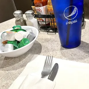 Flatware presented in a protective paper sleeve