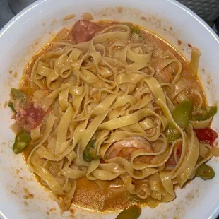 a plate of pasta with meat and vegetables