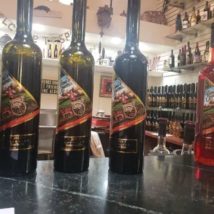 bottles of wine lined up on a bar