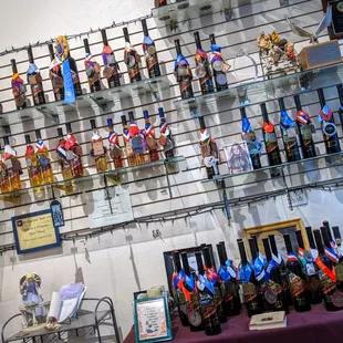 a display of bottles of wine and miniature figurines