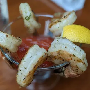 a shrimp cocktail garnished with lemon wedges
