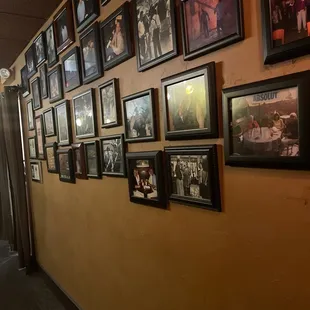 a wall full of framed photos