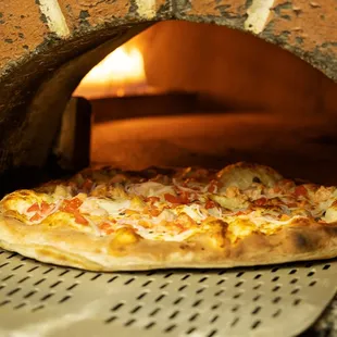 a pizza in a brick oven
