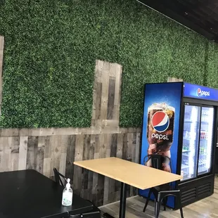 a pepsi vending machine and tables