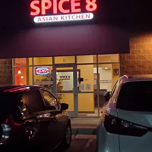 two cars parked in front of the store