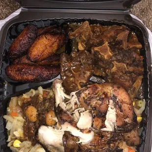 Oxtails, jerk chicken, veggies and plantain