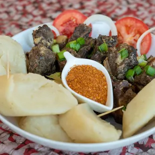 Ntaba (grilled goat) with kwanga (cassava) from Taste of Congo