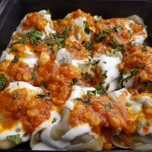 This is Mantu served by Jazze&apos;s! Beef filled dumplings drenched in a delicious red lentil sauce and yogurt mixed with fresh mint!