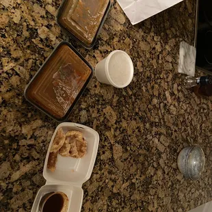Tiny takeout containers. Have never seen this little food from a restaurant.