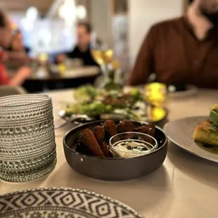 a man sitting at a table with plates of food