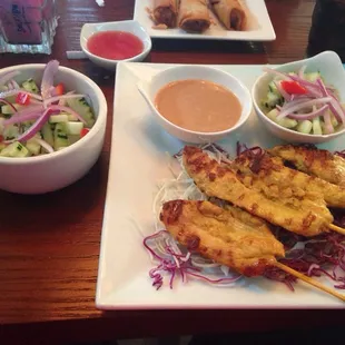 Chicken satay with a regular cucumber salad.