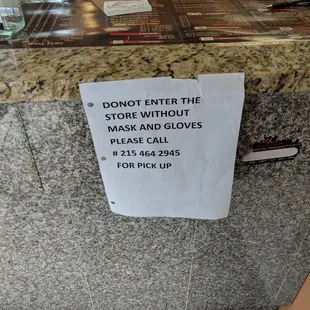 a sign posted on a counter