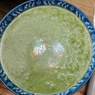 a bowl of broccoli soup on a table