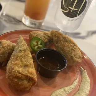 a plate of food with dipping sauce