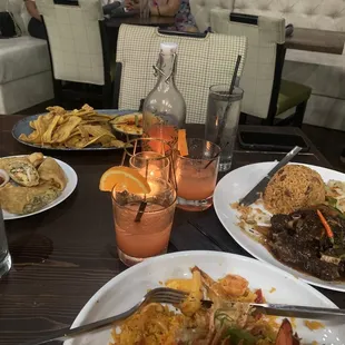 Seafood dip, seafood rice, oxtail meal, jerk chicken egg rolls, and rum punch carafe