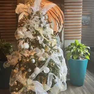 a christmas tree with white and silver decorations