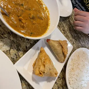 a bowl of curry and a plate of rice