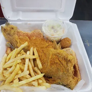 fried fish and french fries in a styrofoam container