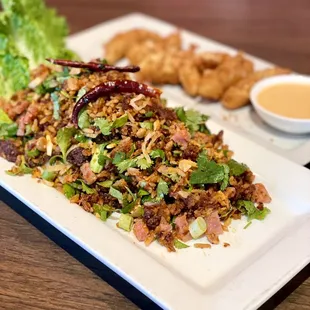 Nam Khao was good. Just don&apos;t order fried squid (in the background). The squid pieces were freezer burned and refried.