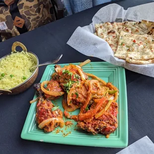 Chicken tandoori served with rice, and garlic naan.