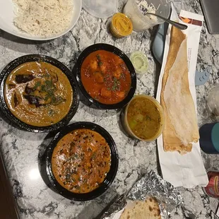 Guthi Vankaya (Eggplant), Butter Chicken Masala, Shrimp Vindaloo, Garlic Naan, Aloo (potato) Naan, and a dosa
