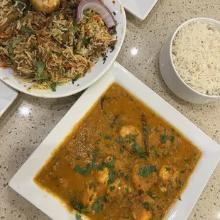 a bowl of rice and a plate of shrimp curry