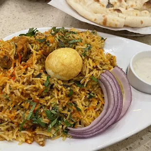 a plate of food with a bowl of sauce