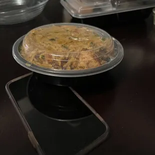 $16 Chicken Dum Biryani next to iPhone to show small potion