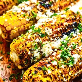 grilled corn on a wooden board