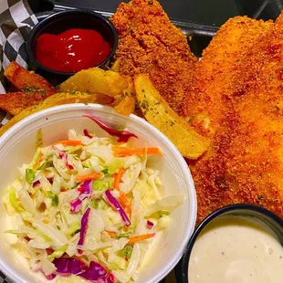 a plate of fried fish, coleslaw and fries