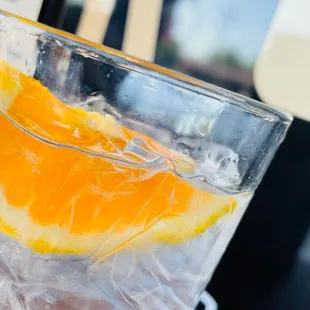 an orange slice in a glass of water