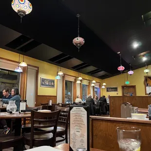 people sitting at tables in a restaurant