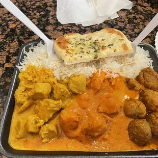 Three entree meal: tiki masala, butter chicken, basmati rice and garlic butter naan.