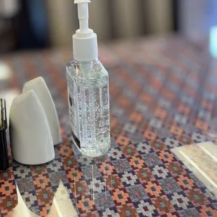 Each table includes seasoning condiment and hand sanitizer