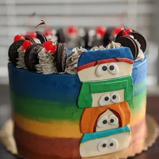 a colorful cake with chocolate cookies and oreos