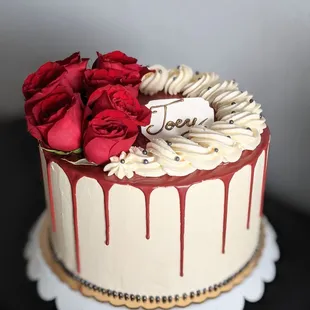 a cake with red roses on top