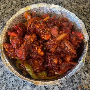 Chilli Chicken....Fried chicken sautéed with onion, tomato and peppers then glazed.  Bomb fusion dish! My son Loved everything :)