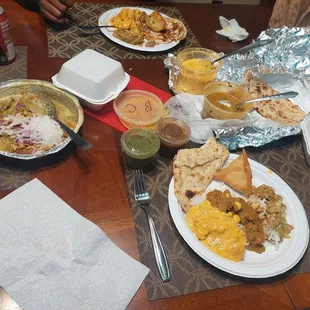 Butter chicken, goat curry, basmati rice, naan, samosas, aloo tikki.