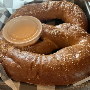  a pretzel with a dipping sauce