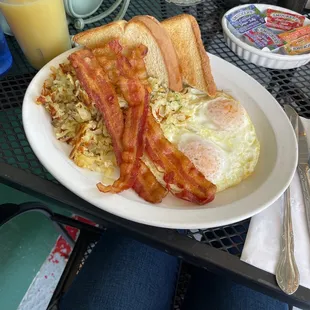 Two egg combo with bacon, hash browns, and toast